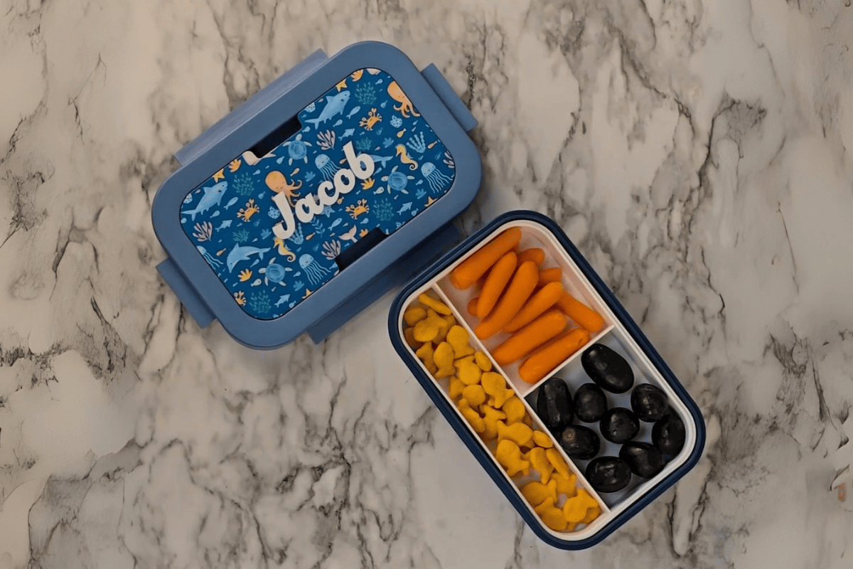 Bento Box with custom Jacob design on outside with carrots, goldfish, and grapes on the inside