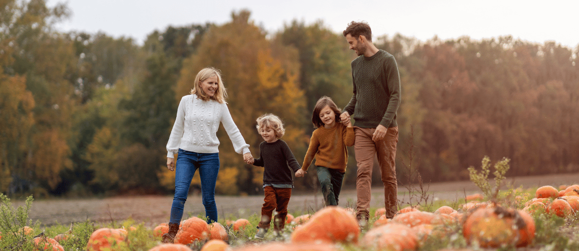 Family walking in pumpkin patch