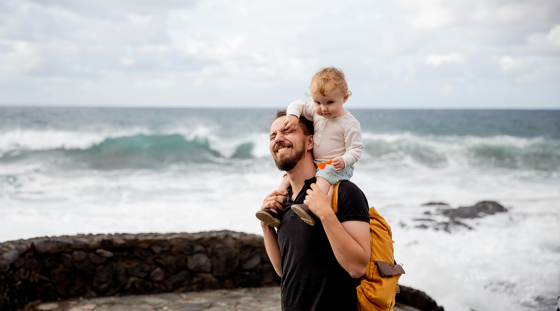 Father and child walking on the beach