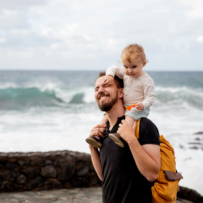 Father and child walking on the beach