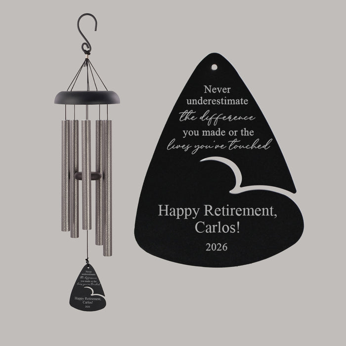 Wind chime with engraved Retirement message on a gray background featuring the retiree's name and year