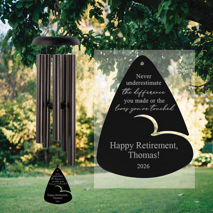 Personalized wind chime with engraved message in a garden setting for retirement gift