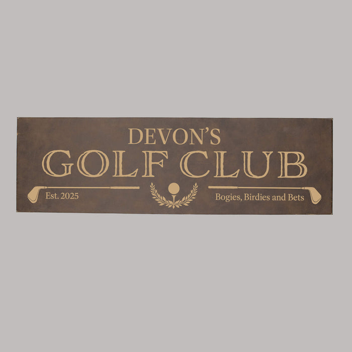Brown sign with engraved text 'Devon's Golf Club' on a gray background