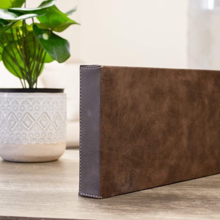 Side view of brown vegan leather wall sign showing the sewn edges