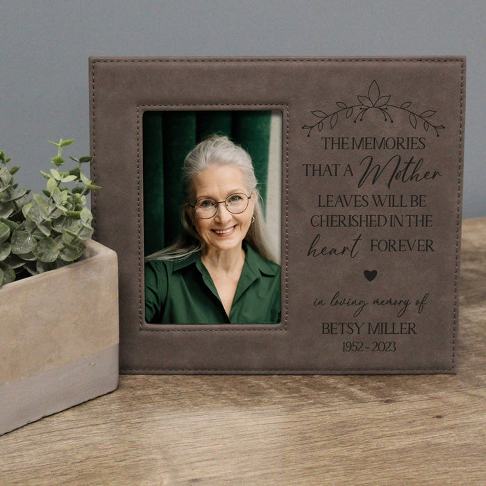 Personalized photo frame with engraved text and a portrait of an elderly woman on a wooden surface.