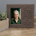 Personalized photo frame with engraved text and a portrait of an elderly woman on a wooden surface.