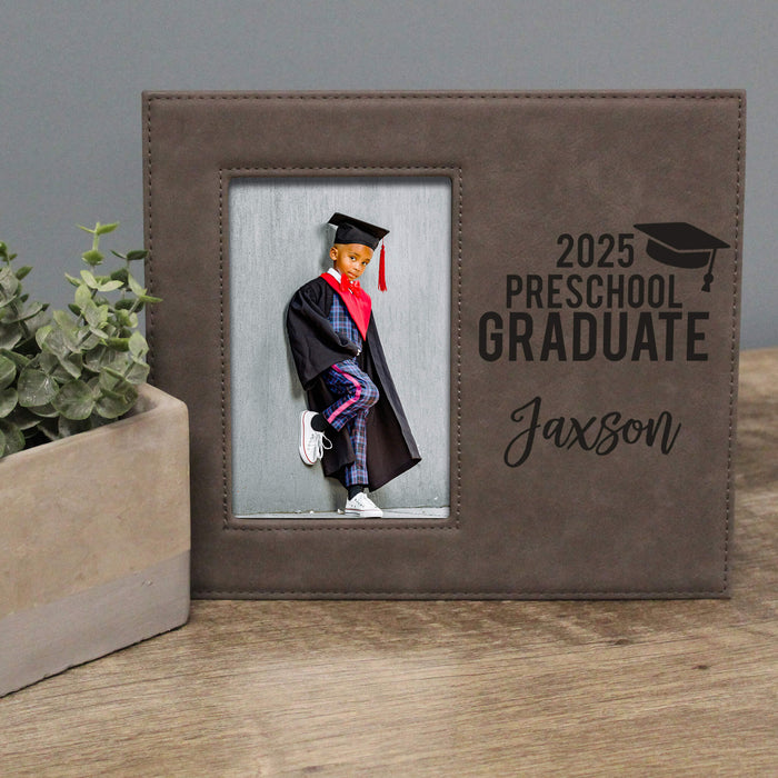 Graduation-themed photo frame with a young graduate's picture and '2025 Preschool Graduate Jaxson' text.