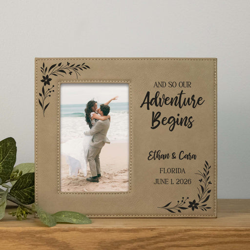 Beige photo frame with 'And so our Adventure Begins' text and a couple on a beach