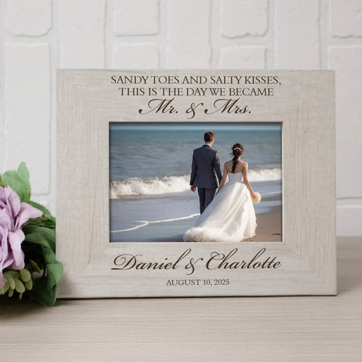 Personalized photo frame with a couple on a beach and engraved text.