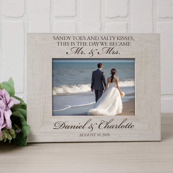 Personalized photo frame with a couple on a beach and engraved text.