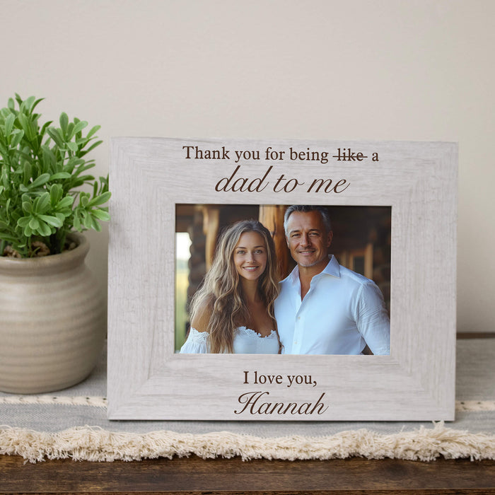 Personalized photo frame with a picture of a stepfather and daughter and engraved text on a wooden surface.