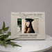 Graduation-themed photo frame with a personalized engraving on a white surface.