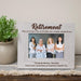 Personalized retirement photo frame with a picture of four women and a message from coworkers on a wooden surface.