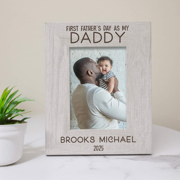 Personalized photo frame with a picture of a father and child, text 'First Father's Day as my Daddy' and personalized with a name and year