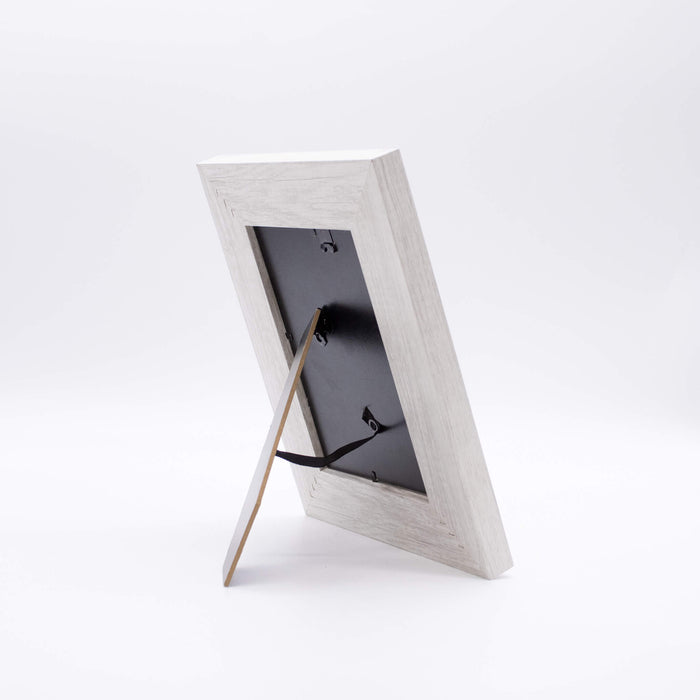 Back of a wooden picture frame on a white background