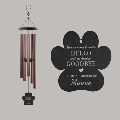 Memorial wind chime with paw-shaped tag in memory of a pet on a gray background