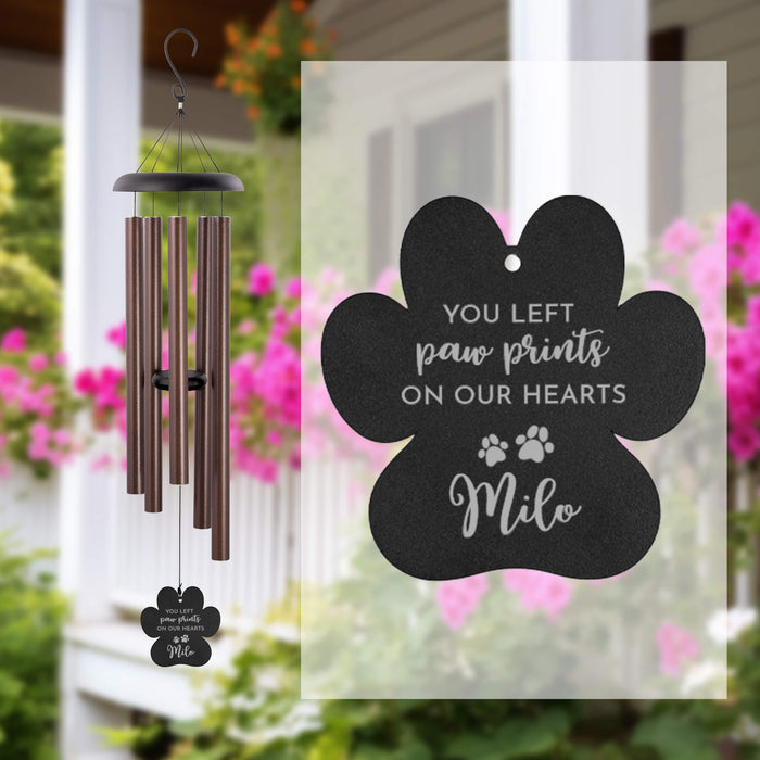 Wind chime with a personalized pet memorial sail on a blurred outdoor background