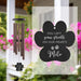 Wind chime with a personalized pet memorial sail on a blurred outdoor background