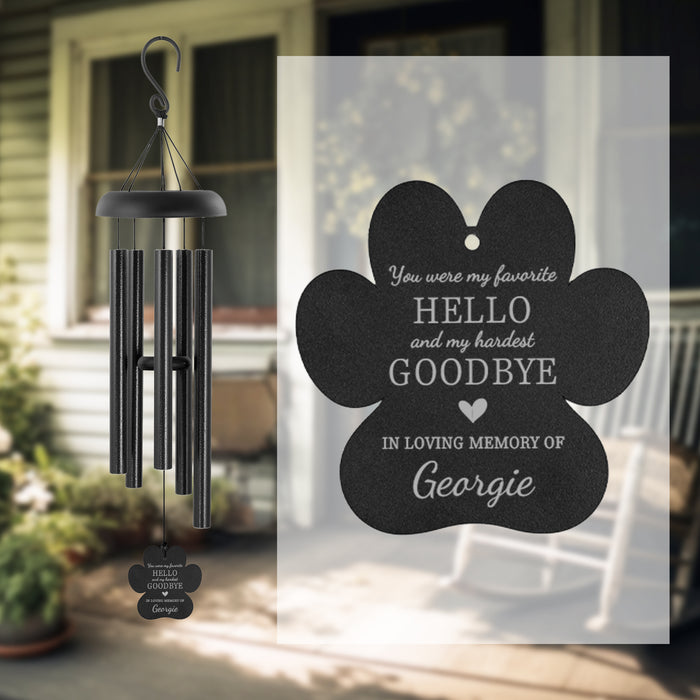 Black wind chime engraved with "you were my favorite hello and my hardest goodbye" with a memorial tag personalized with name of pet on a porch.