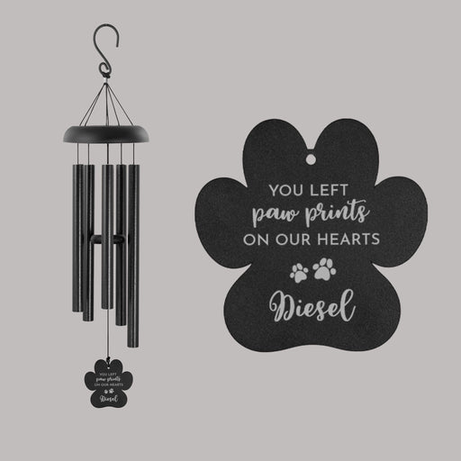 Black wind chime with paw print design and text on a gray background