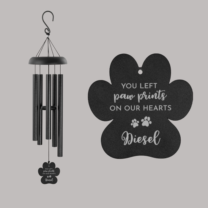 Black wind chime with paw print design and text on a gray background