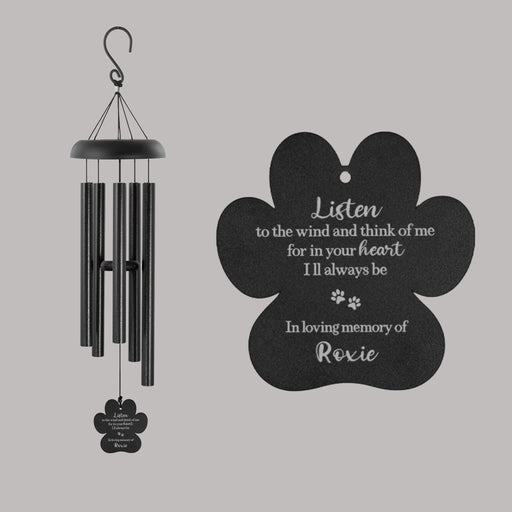 Black wind chime with paw-shaped sail on gray background
