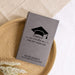 Gray journal engraved with 'Words of Wisdom for the Graduate' with a graduation cap design on a woven mat