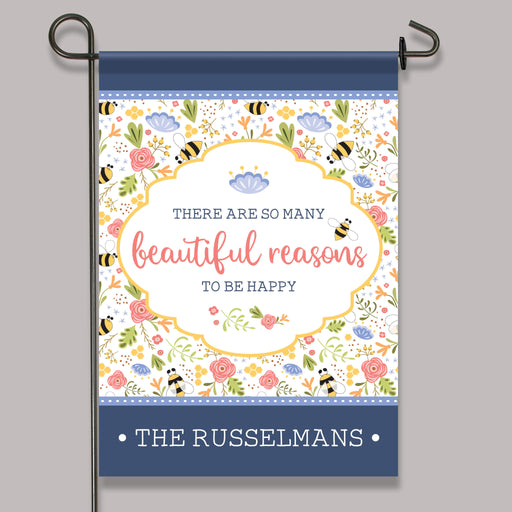 Decorative garden flag with floral design and text on a gray background