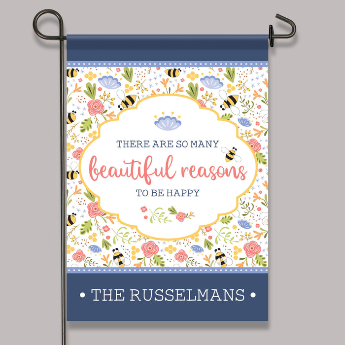 Decorative garden flag with floral design and text on a gray background
