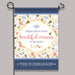Decorative garden flag with floral design and text on a gray background