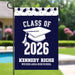 Personalized graduation-themed garden flag with 'Class of 2026' design displayed by a pool.