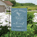 Garden flag with 'Last Toast on the Coast' text and design, set against a natural background with flowers and a house.