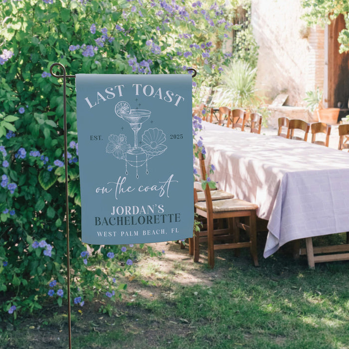 Decorative sign for a bachelorette party in an outdoor setting with a table and chairs.