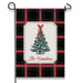 A vertical garden flag on a black metal stand, featuring a black, red, and green plaid pattern with a central cream label showing a decorated Christmas tree and the text 'The Camdens'.