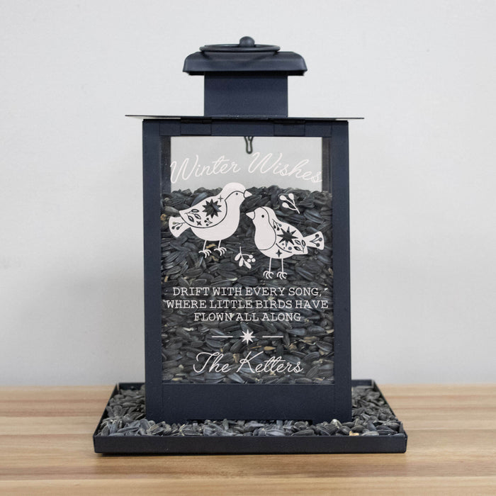 black metal bird feeder engraved with a Winter Wishes poem, a graphic of two birds, and personalized with a family's last name