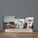 Three photo prints on a wooden stand with 'Mckinny Family Vacation' text against a gray wall.
