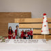 Christmas picture display bar engraved with a holiday saying and custom names. The photo bar is rustic white and comes with two acrylic pane inserts to display your photos in.