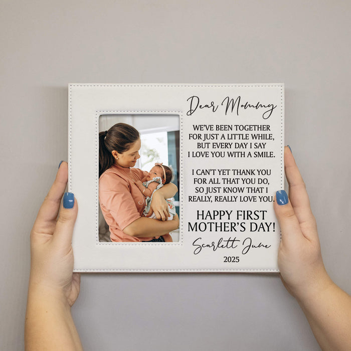 Personalized photo frame with a message for Mother's Day, held by two hands.