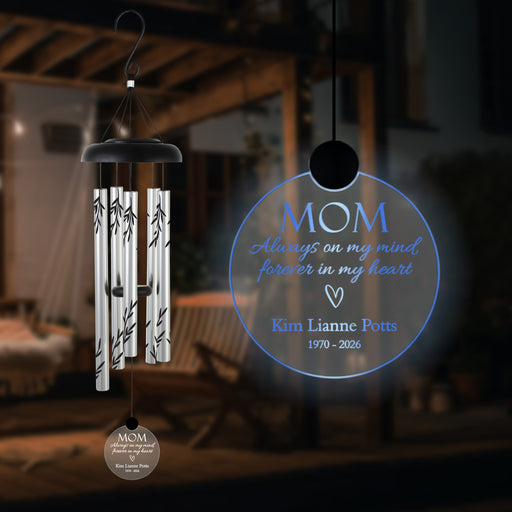 mother memorial custom solar wind chime with name and years of life hanging outside in the dark 