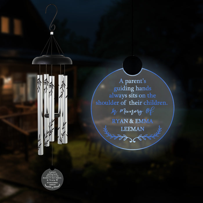 Hanging wind chime with engraved memorial message for loss of parents in the dark