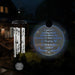 Hanging wind chime with engraved memorial message for loss of parents in the dark