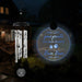 Hanging wind chime with a glowing circular plaque in the dark for pet memorial