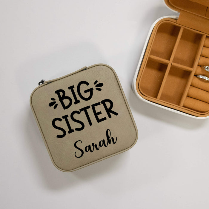 Beige jewelry case with 'BIG SISTER' text on a gray background