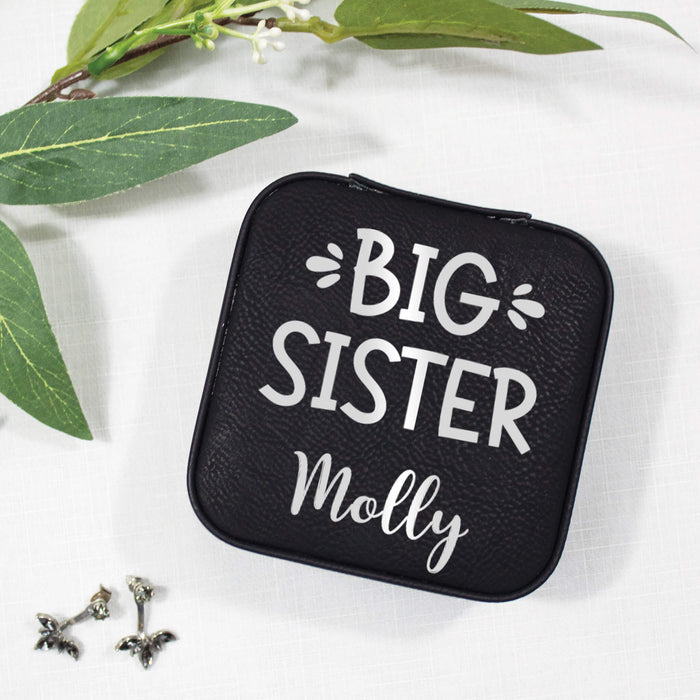 Black jewelry case with 'Big Sister' text on a white background with green leaves.