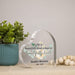 acrylic heart memorial plaque with name and years of life beside a potted plant and decorative beads
