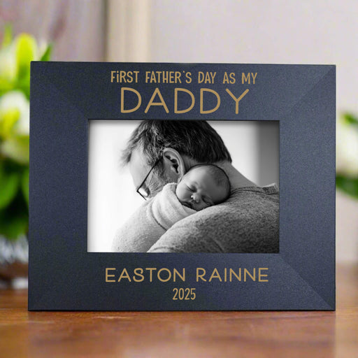 Personalized photo frame for Father's Day with a black and white photo of a father holding a baby.