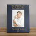 Black photo frame with a picture of a father holding a baby, text 'First Father's Day as my Daddy' and personalized with name and year on a wooden surface.