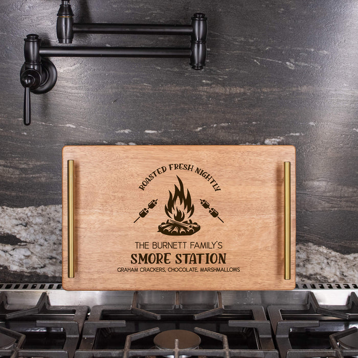 Wooden serving tray with a "S'more Station" design on a kitchen stove