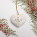 A heart-shaped wooden ornament hanging from a natural twine string, engraved with the text 'The WATTS Est. 2026' in brown lettering.