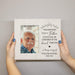 Memorial picture frame with a portrait of an elderly man and engraved text on a plain background
